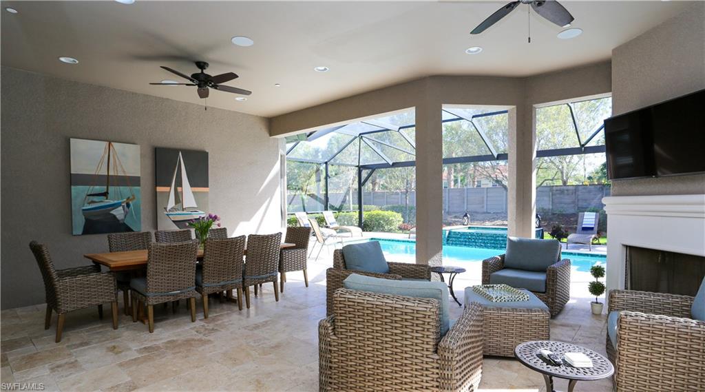 10155 Coconut Road Estero, FL 34135 - Photo 30 of 34 a living room with furniture a flat screen tv and a fireplace