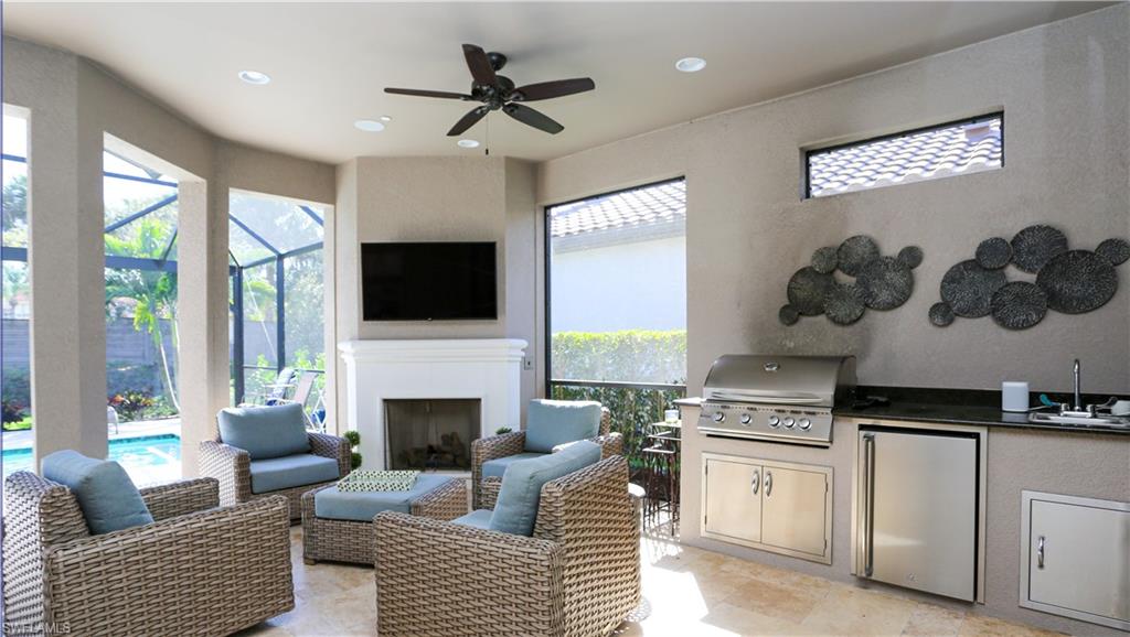 10155 Coconut Road Estero, FL 34135 - Photo 31 of 34 a living room with furniture fireplace and flat screen tv