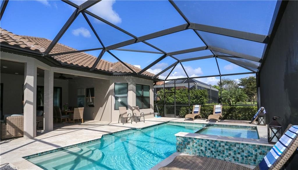 10155 Coconut Road Estero, FL 34135 - Photo 33 of 34 a view of a backyard with table and chairs under an umbrella