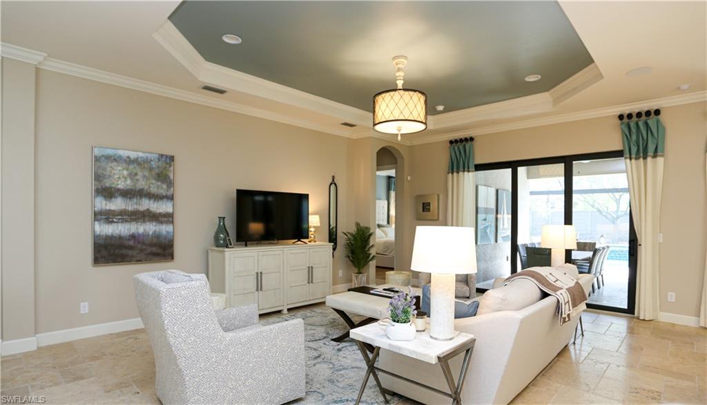 10155 Coconut Road Estero, FL 34135 - Photo 6 of 34 a living room with furniture a large window and a flat screen tv