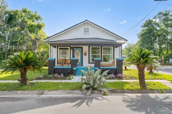 a front view of a house with a yard and a porch