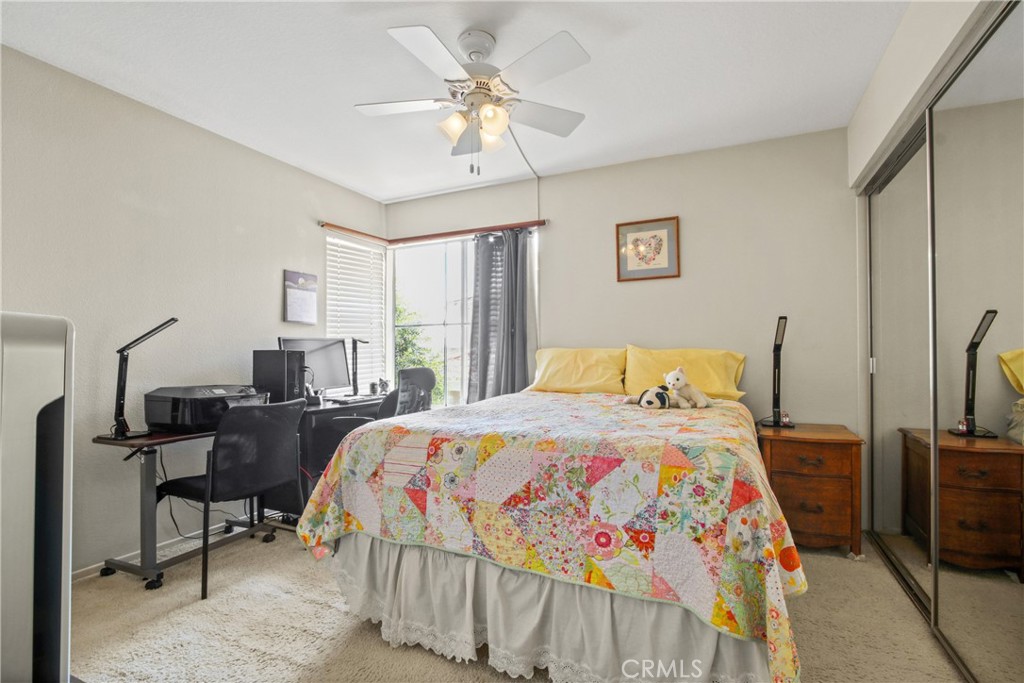 9221 Belcaro Drive Huntington Beach, CA 92646 - Photo 17 of 22 a bedroom with a bed a table and a chandelier