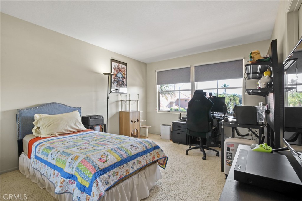 9221 Belcaro Drive Huntington Beach, CA 92646 - Photo 21 of 22 a bedroom with a bed and a desk