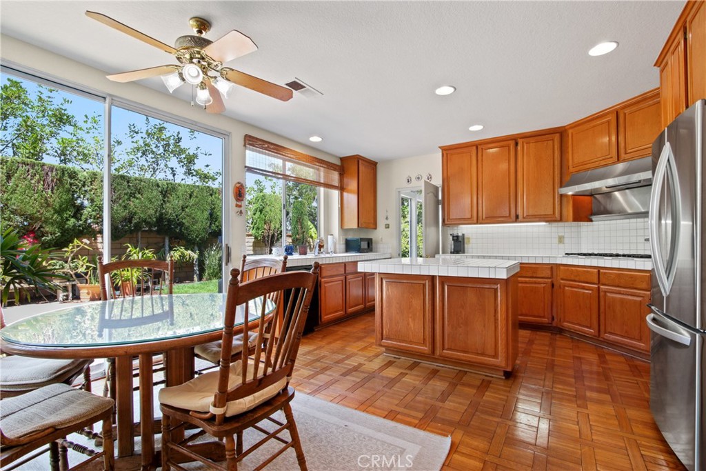 9221 Belcaro Drive Huntington Beach, CA 92646 - Photo 7 of 22 a kitchen with a dining table chairs and granite counter top