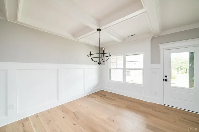 a view of a kitchen with kitchen island a sink wooden floor and appliances