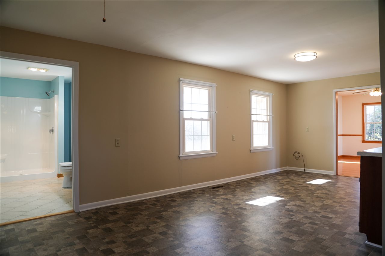 5163 East Timber Ridge Road Mount Crawford, VA 22841 - Photo 32 of 48 an empty room with windows and wooden floor