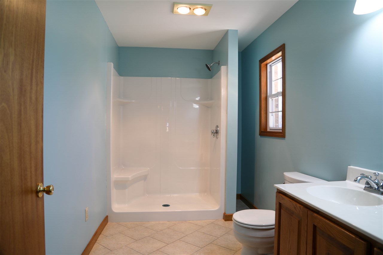 5163 East Timber Ridge Road Mount Crawford, VA 22841 - Photo 40 of 48 a bathroom with a granite countertop sink a toilet and shower