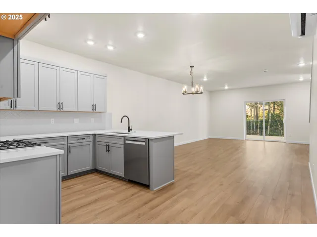 a kitchen with a sink cabinets and window