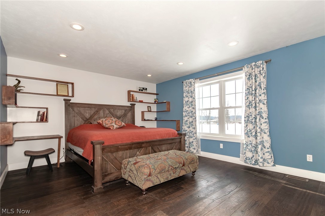 18919 Ravenna Road Chagrin Falls, OH 44023 - Photo 15 of 48 1st floor Primary Bedroom with wood floors and custom shelving