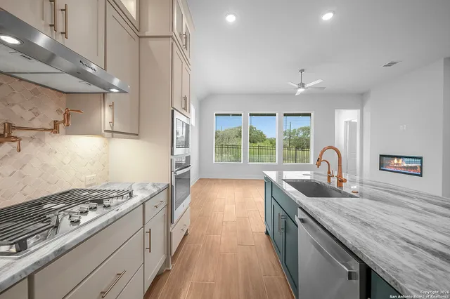 a kitchen with granite countertop a stove and a sink