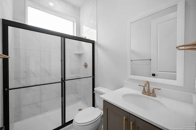 a bathroom with a sink a toilet and a mirror