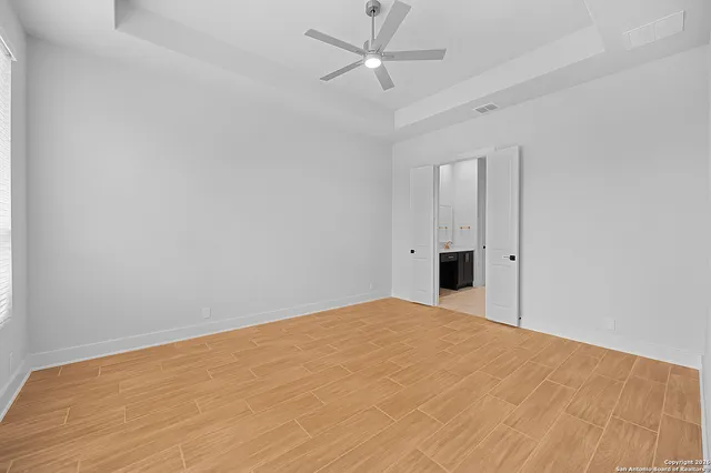 a view of an empty room with a ceiling fan