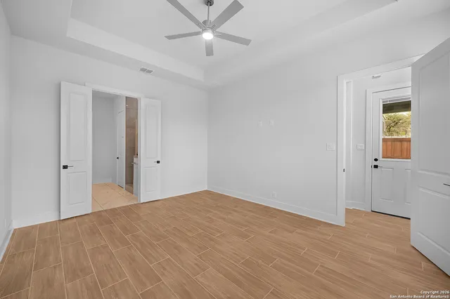 a view of a big room with wooden floor and closet area