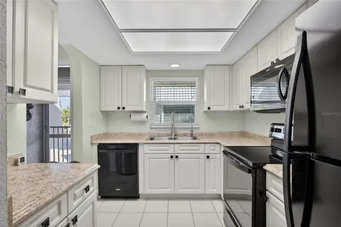 a kitchen with a sink stove and refrigerator