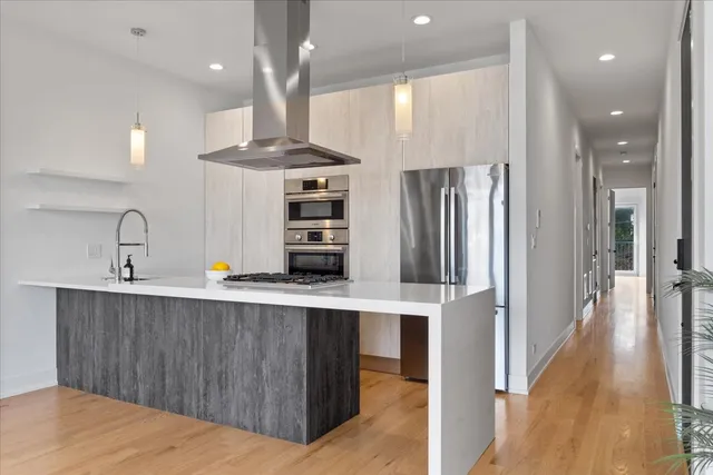 a kitchen with stainless steel appliances a refrigerator and a sink