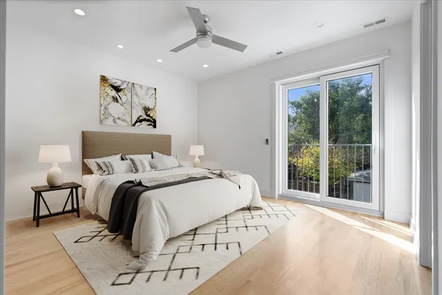 a bedroom with a large bed and a large window