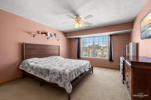 a bedroom with a bed dresser and a window