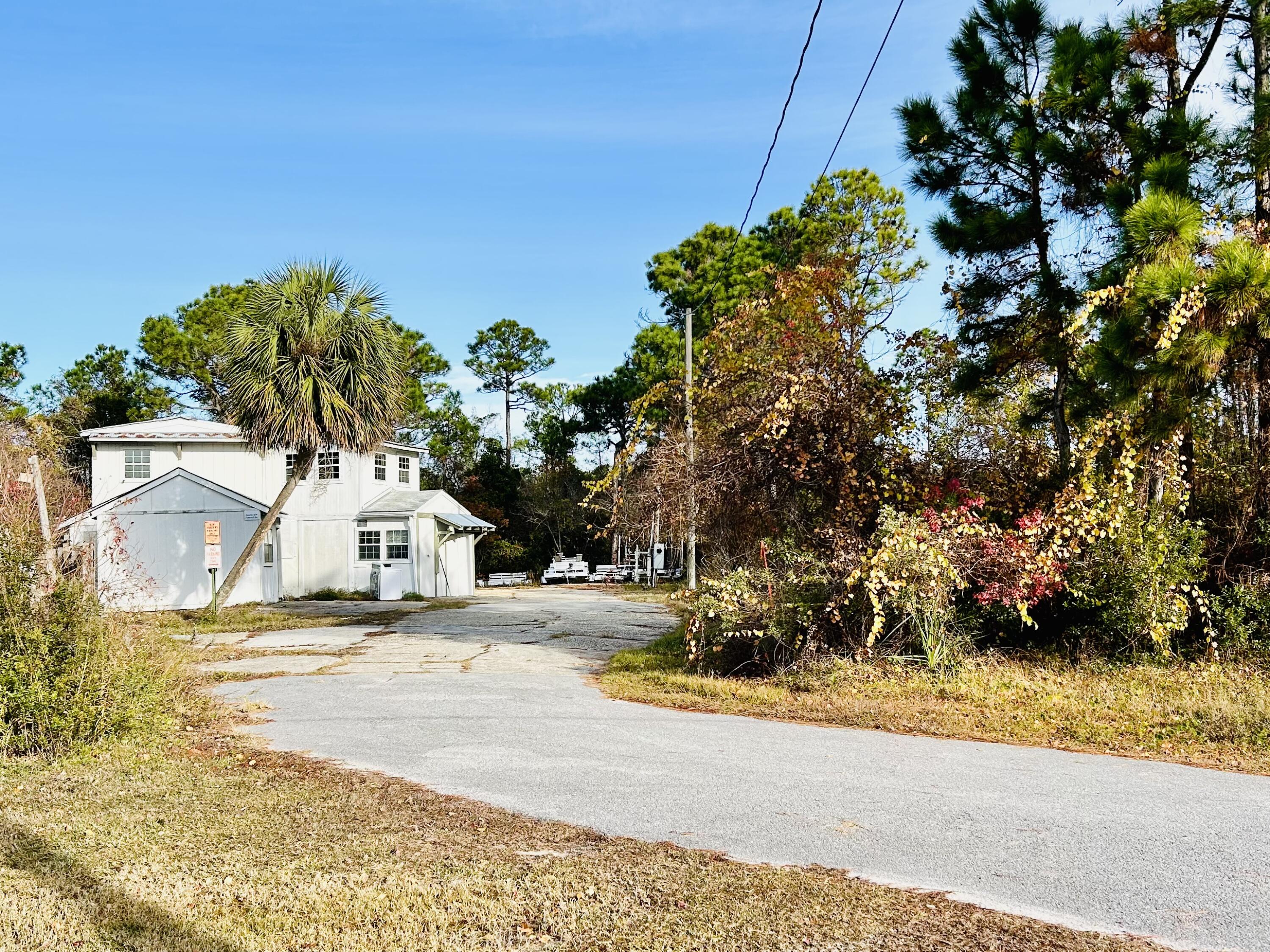 139 North Holiday Road Miramar Beach, FL 32550 - Photo 4 of 5 a view of a yard with plants and trees