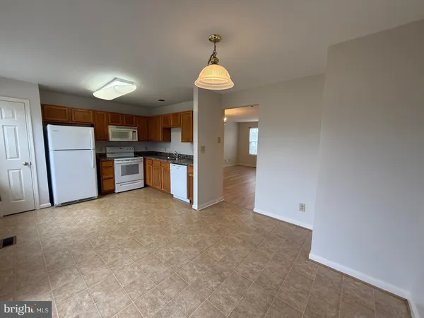 a view of a kitchen with a stove cabinets and a refrigerator