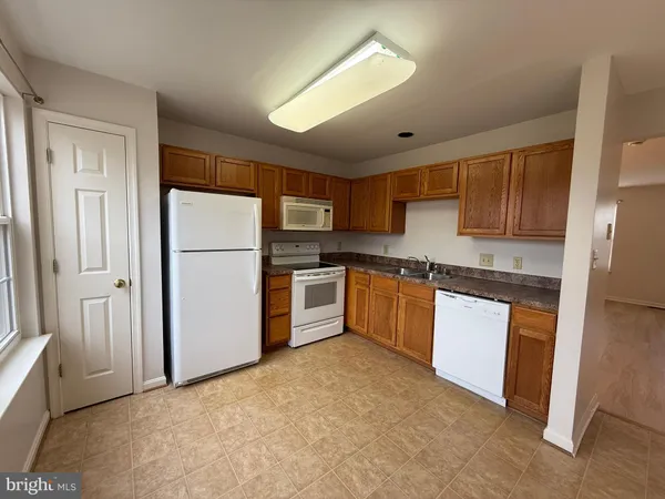 a kitchen with stainless steel appliances granite countertop a refrigerator sink and cabinets