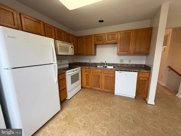 a utility room with cabinets washer and dryer