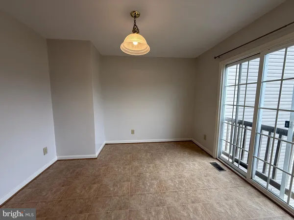 a view of an empty room and a window