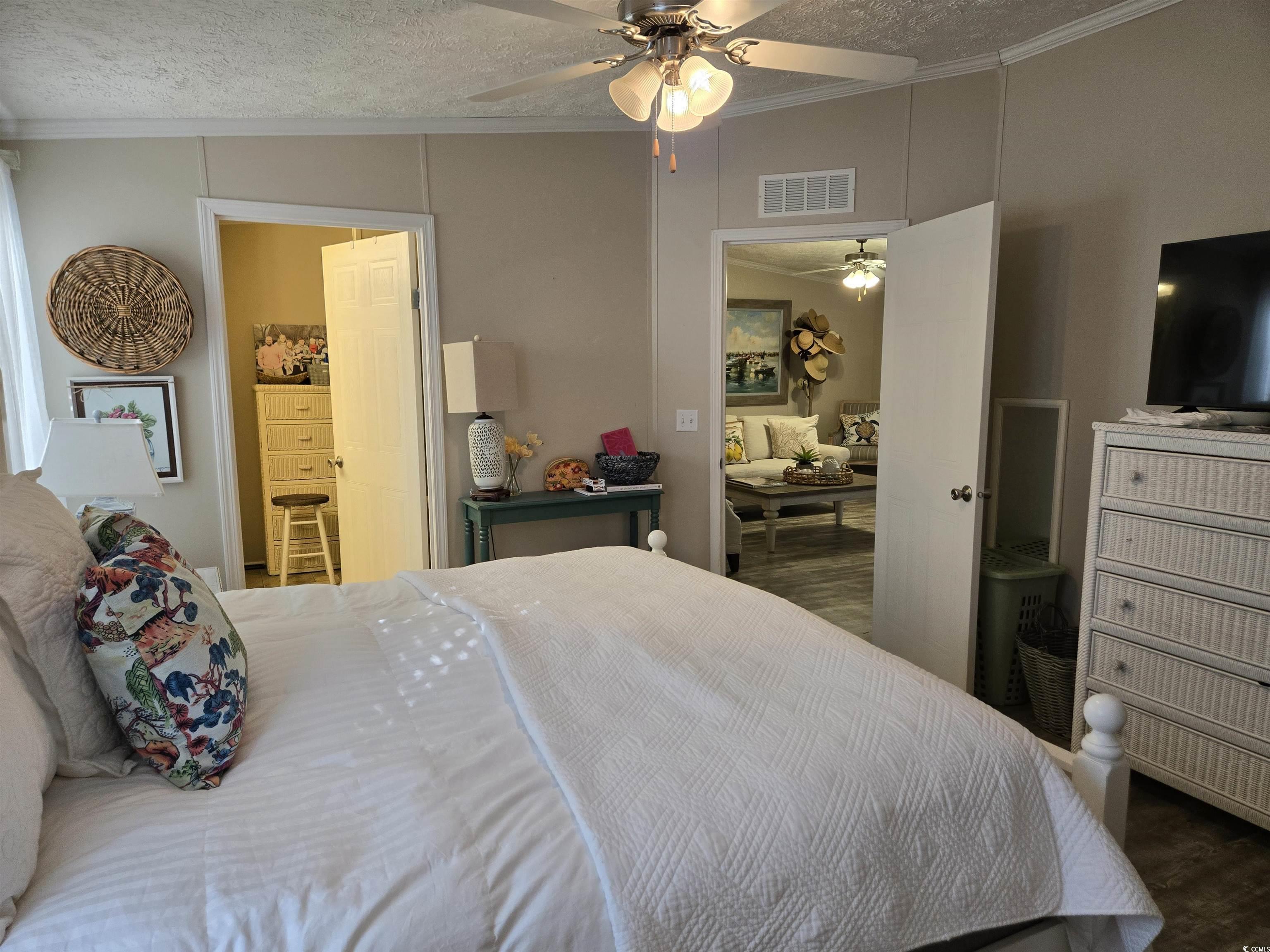 310 Clam Shell Circle Murrells Inlet, SC 29576 - Photo 19 of 32 Bedroom with crown molding, wood finished floors, a textured ceiling, and a ceiling fan