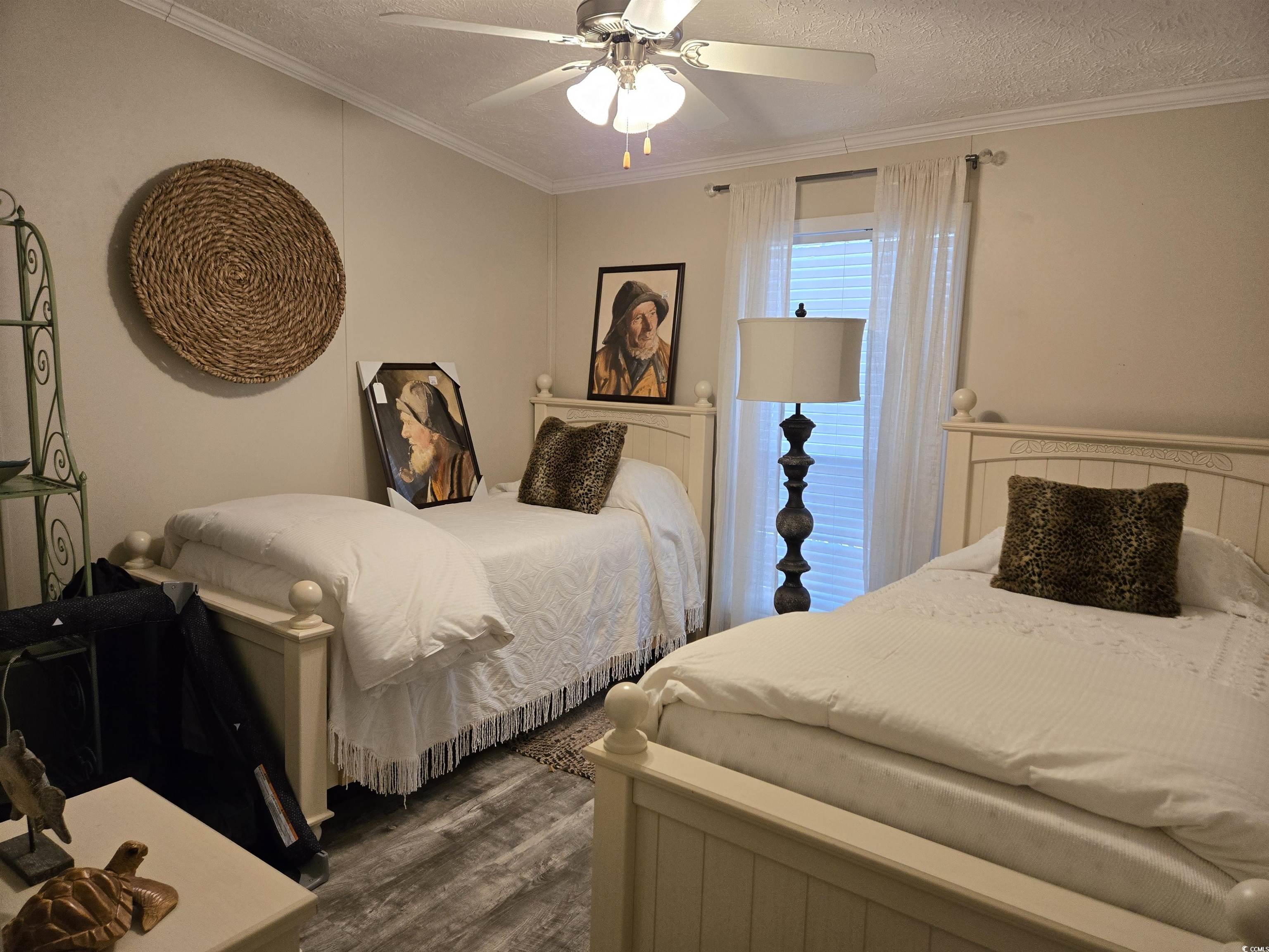 310 Clam Shell Circle Murrells Inlet, SC 29576 - Photo 20 of 32 Bedroom featuring dark wood-type flooring, a textured ceiling, ornamental molding, and a ceiling fan