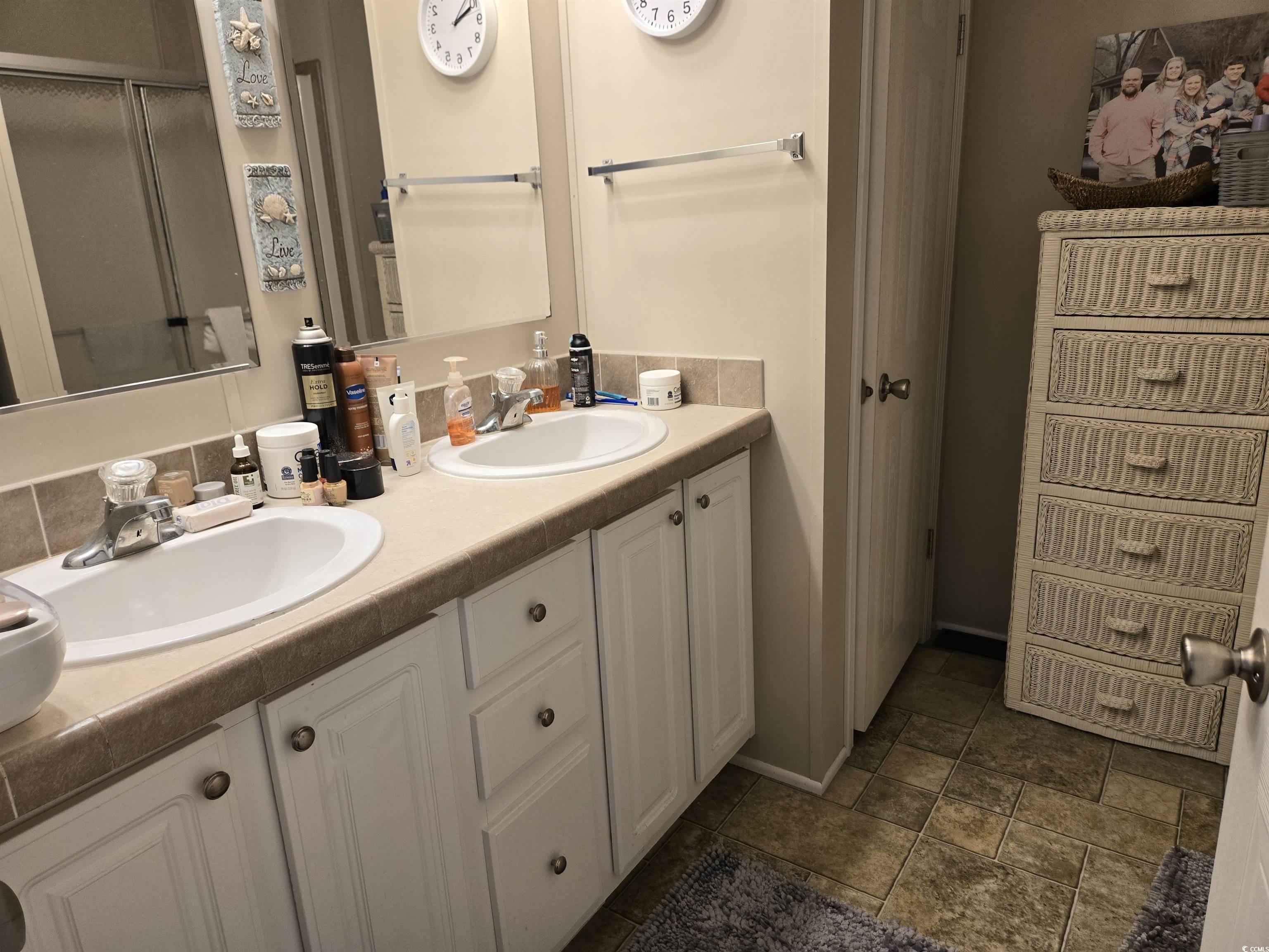 310 Clam Shell Circle Murrells Inlet, SC 29576 - Photo 22 of 32 Full bathroom with double vanity, stone finish flooring, a shower with shower door, and baseboards