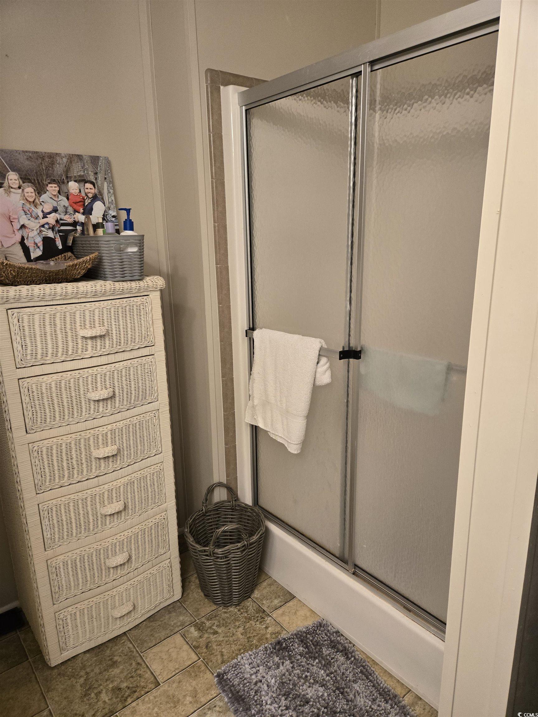 310 Clam Shell Circle Murrells Inlet, SC 29576 - Photo 24 of 32 Bathroom with a stall shower and stone finish flooring