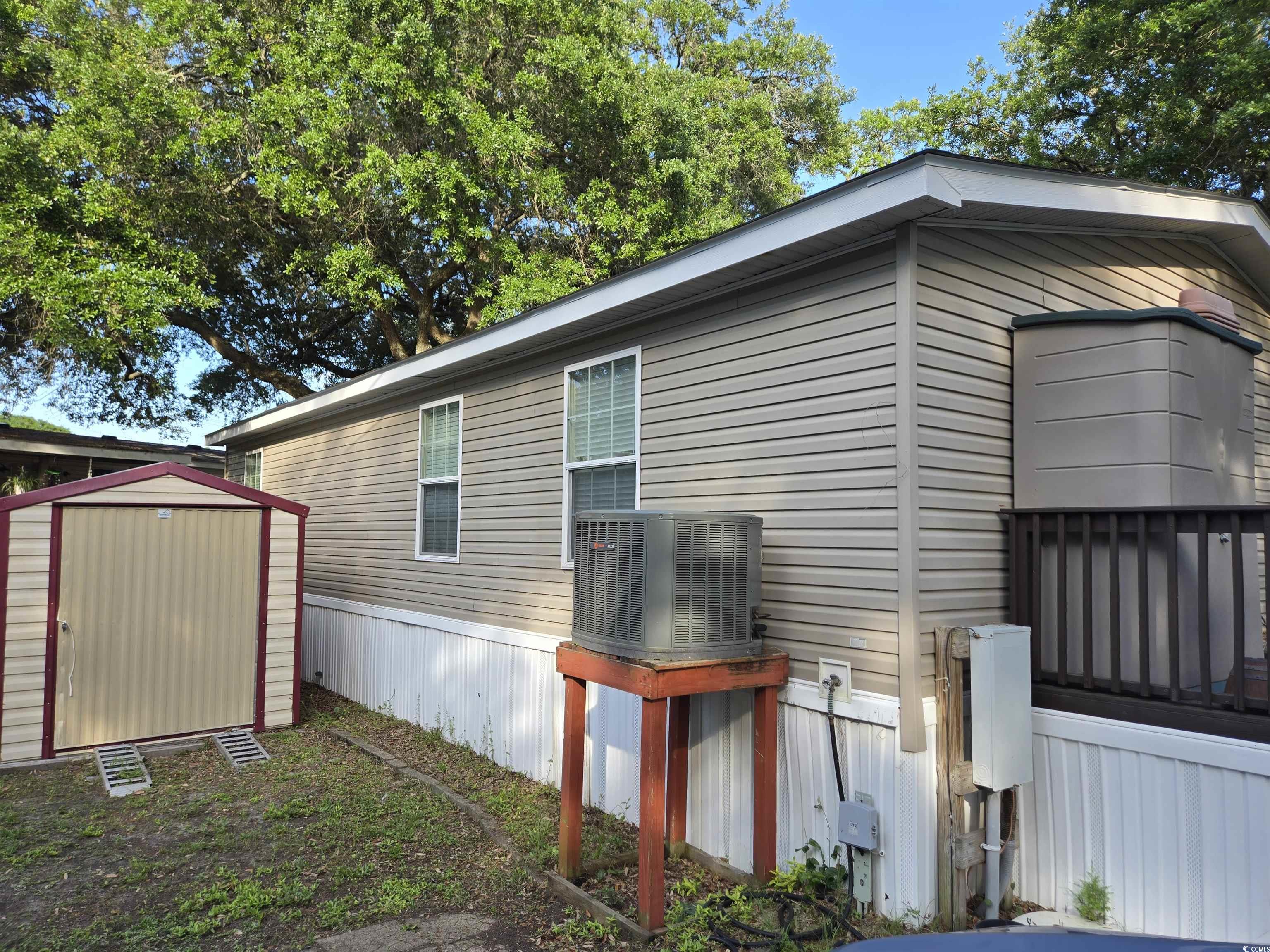 310 Clam Shell Circle Murrells Inlet, SC 29576 - Photo 4 of 32 View of side of home featuring central AC unit