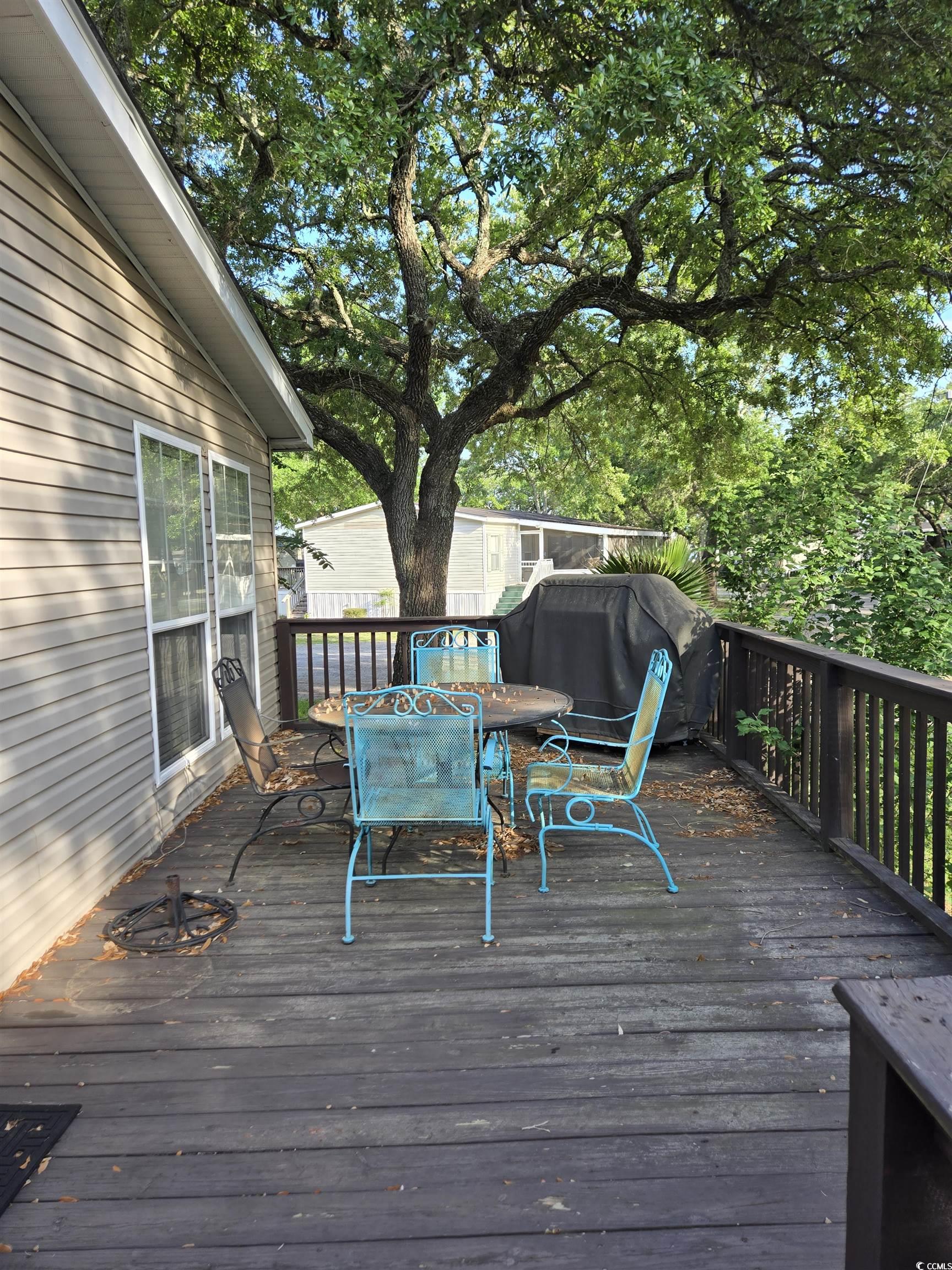 310 Clam Shell Circle Murrells Inlet, SC 29576 - Photo 7 of 32 Wooden terrace featuring outdoor dining space