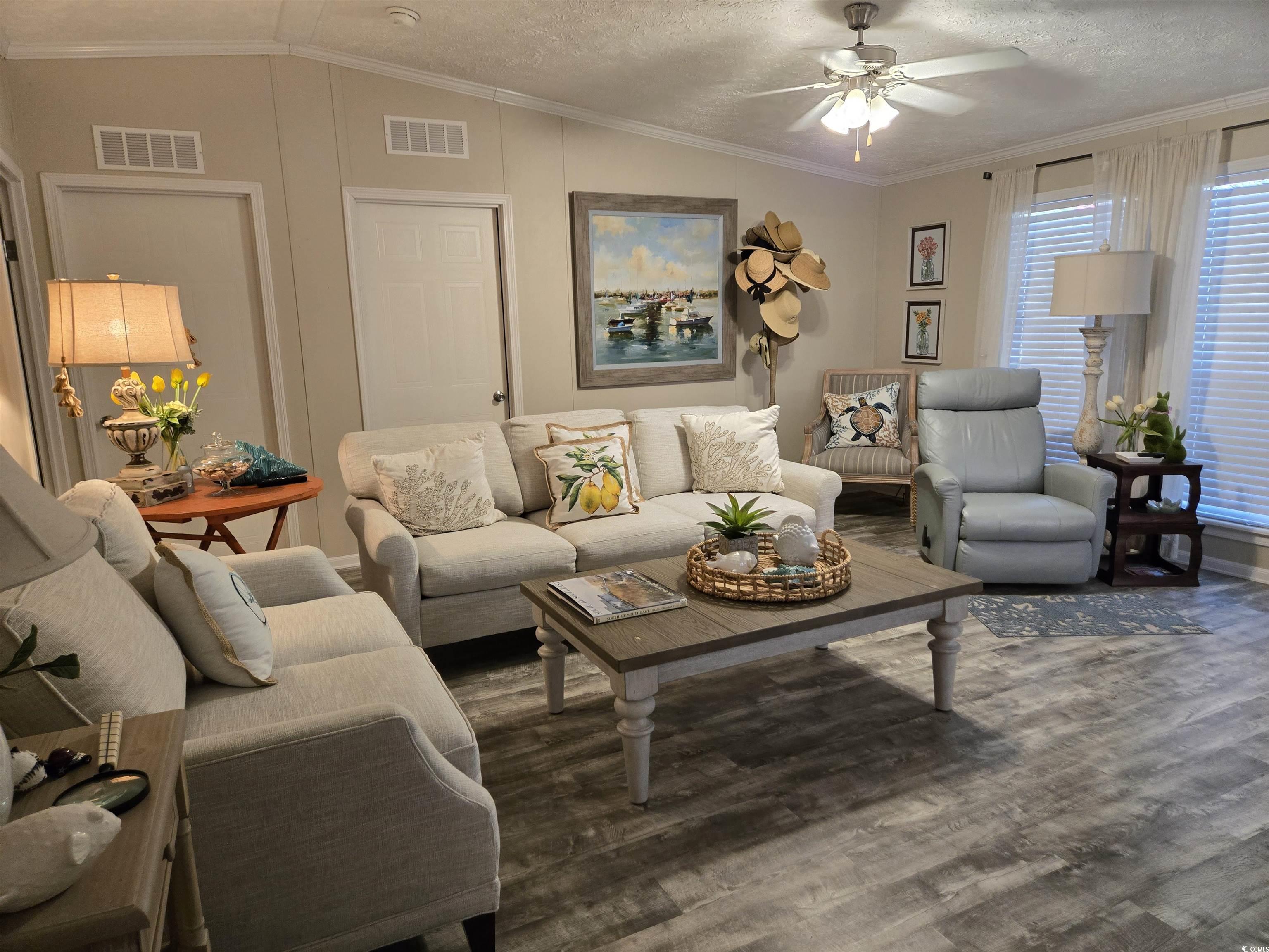 310 Clam Shell Circle Murrells Inlet, SC 29576 - Photo 10 of 32 Living area featuring wood finished floors, ceiling fan, crown molding, lofted ceiling, and a textured ceiling