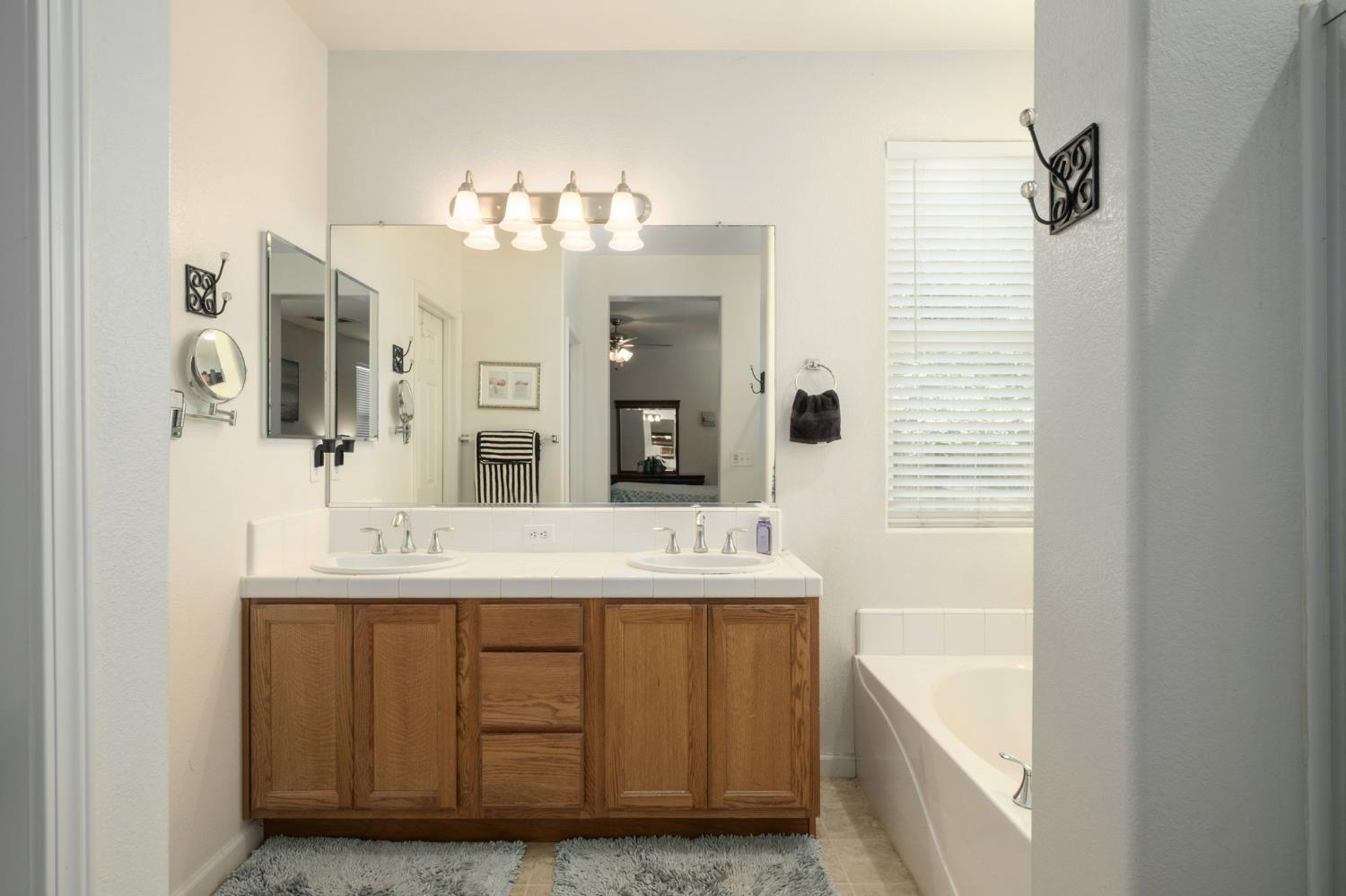 454 Sierra Avenue Reedley, CA 93654 - Photo 17 of 25 a bathroom with a sink and a mirror