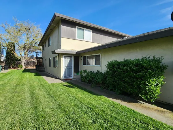 a front view of a house with garden