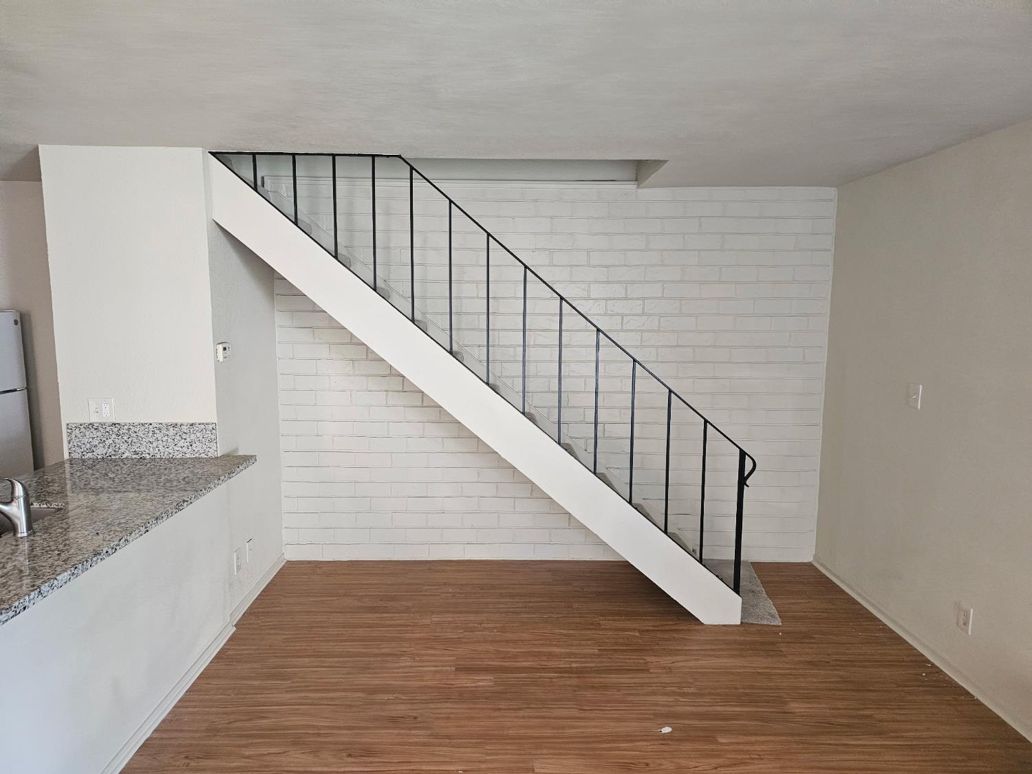 5830 Walerga Road, Unit 2 Sacramento, CA 95842 - Photo 3 of 8 a view of staircase with wooden floor and staircase