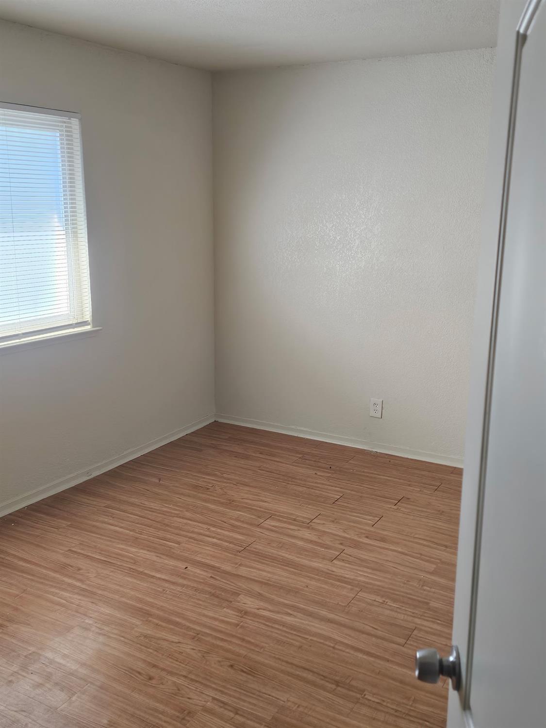 5830 Walerga Road, Unit 2 Sacramento, CA 95842 - Photo 7 of 8 an empty room with a window