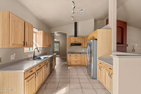 a kitchen with a sink a stove and refrigerator