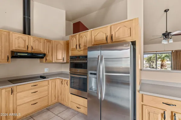 a kitchen with white cabinets and a refrigerator