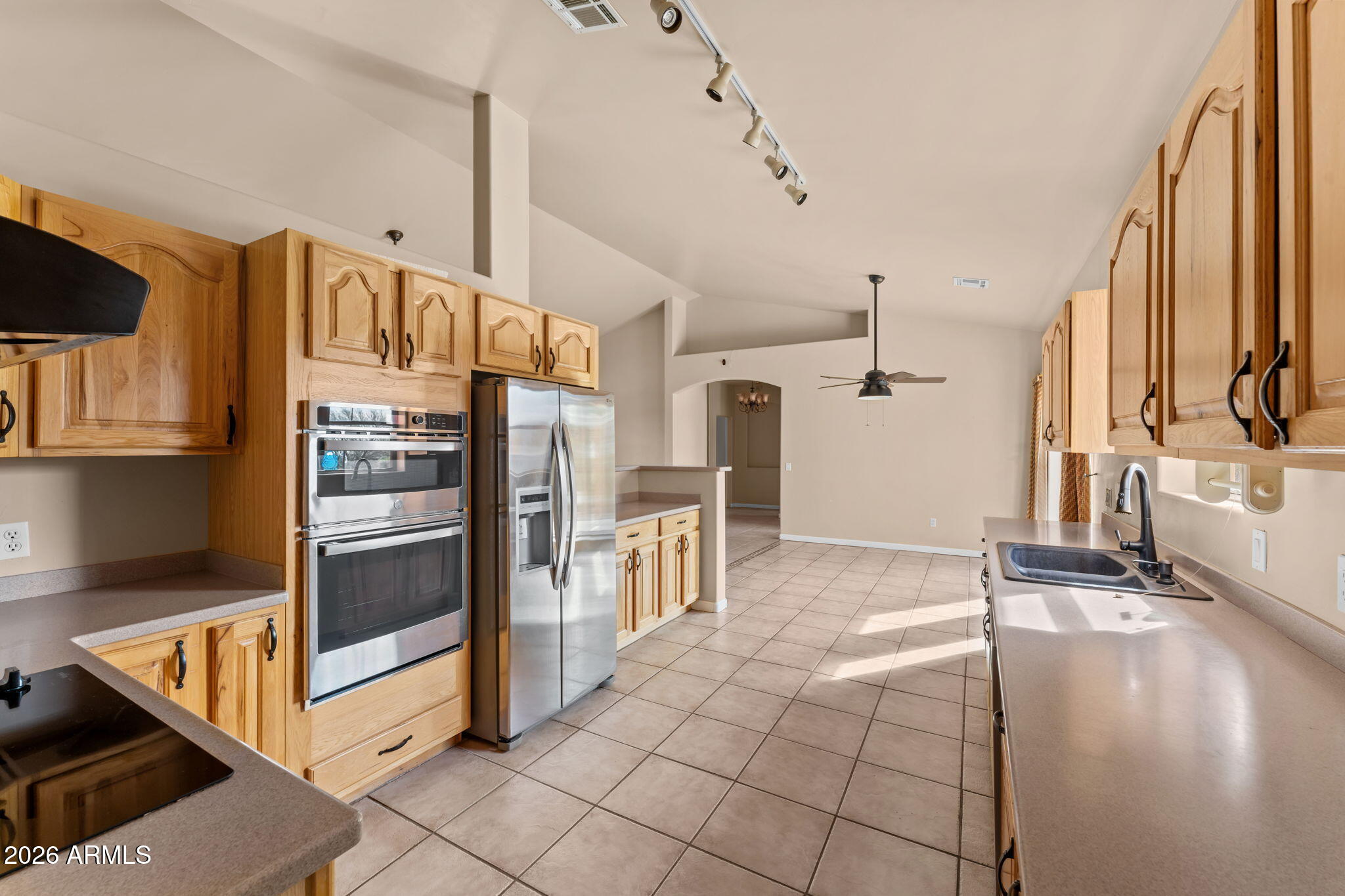 21340 Date Creek Road Wickenburg, AZ 85390 - Photo 16 of 35 a kitchen with stainless steel appliances granite countertop a refrigerator and a stove top oven