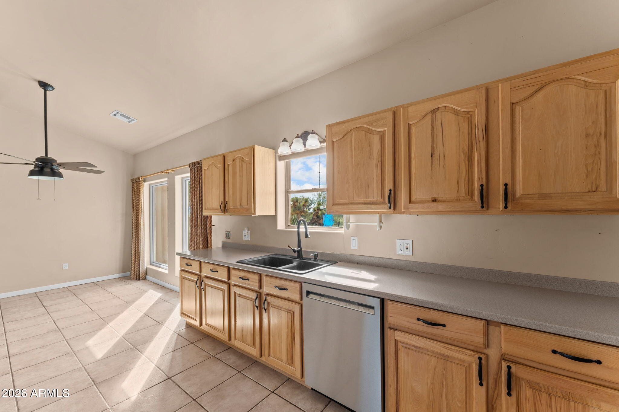 21340 Date Creek Road Wickenburg, AZ 85390 - Photo 17 of 35 a kitchen with stainless steel appliances granite countertop a sink stove and cabinets