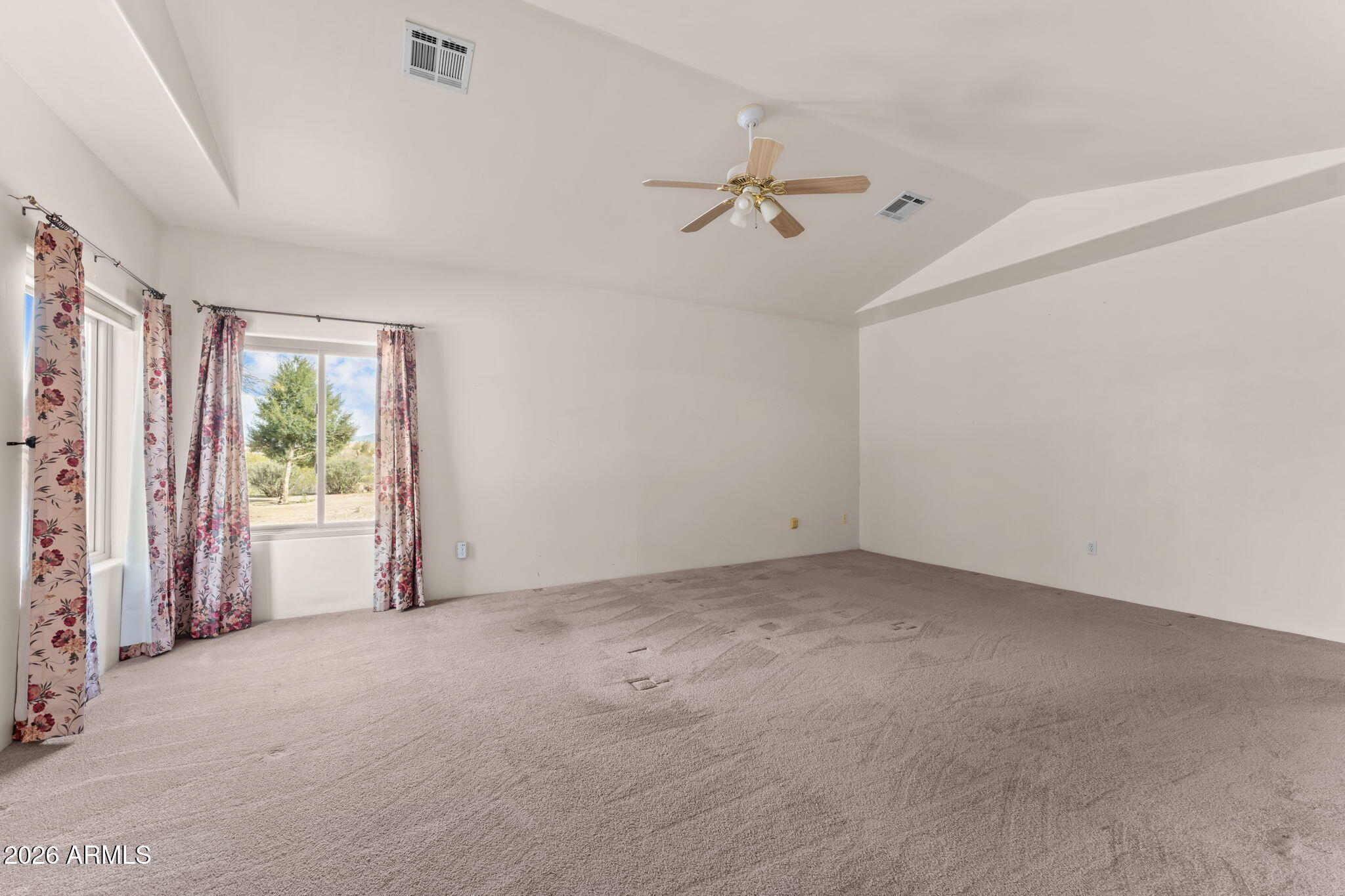 21340 Date Creek Road Wickenburg, AZ 85390 - Photo 19 of 35 an empty room with windows and fan