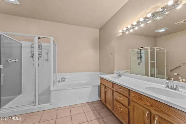 a bathroom with a double vanity sink mirror and shower