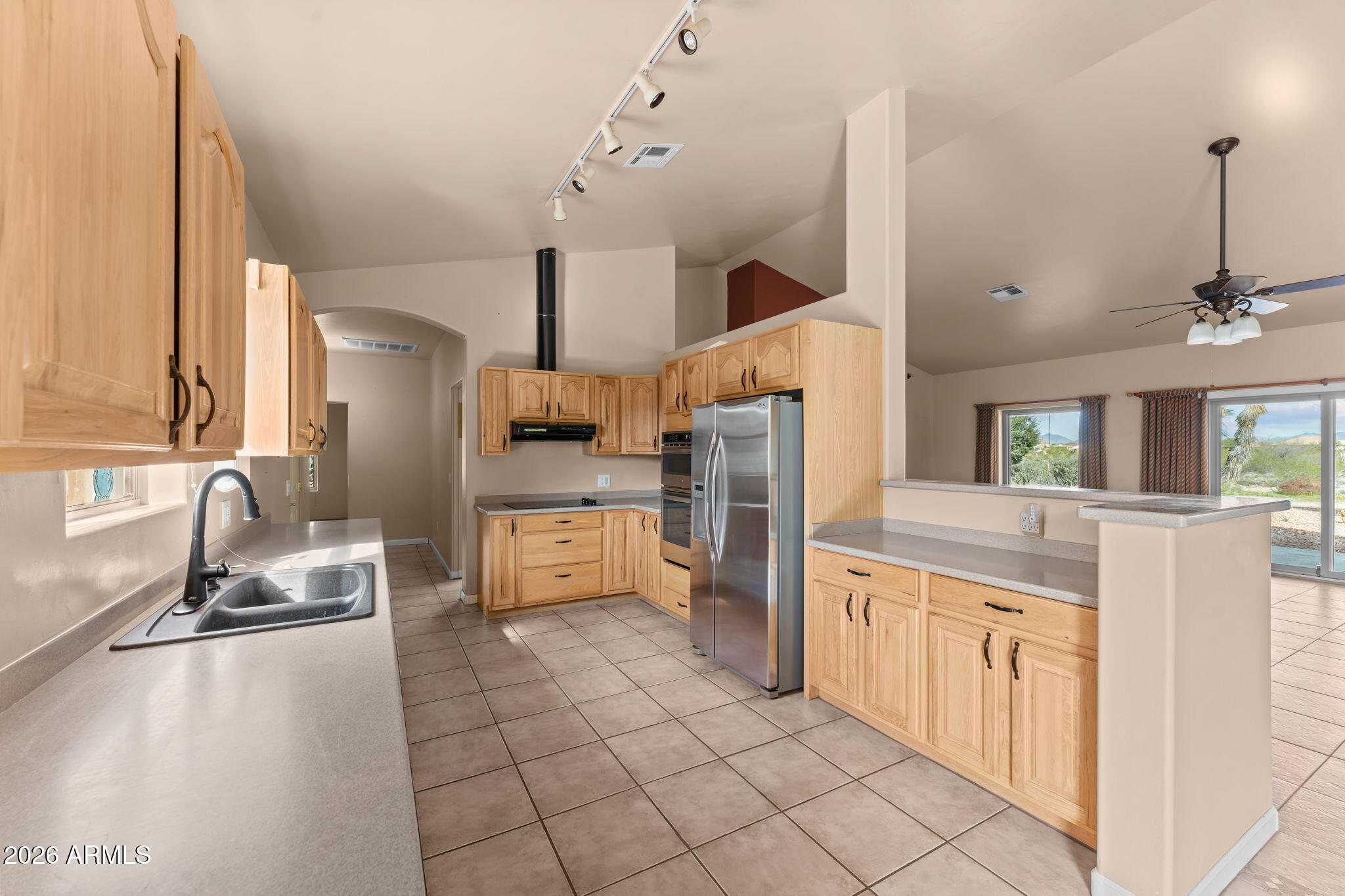 21340 Date Creek Road Wickenburg, AZ 85390 - Photo 2 of 35 a kitchen with stainless steel appliances granite countertop a sink and a refrigerator