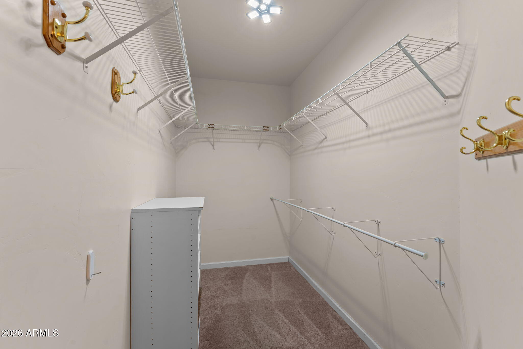 21340 Date Creek Road Wickenburg, AZ 85390 - Photo 21 of 35 a view of storage and utility room with racks on the wall