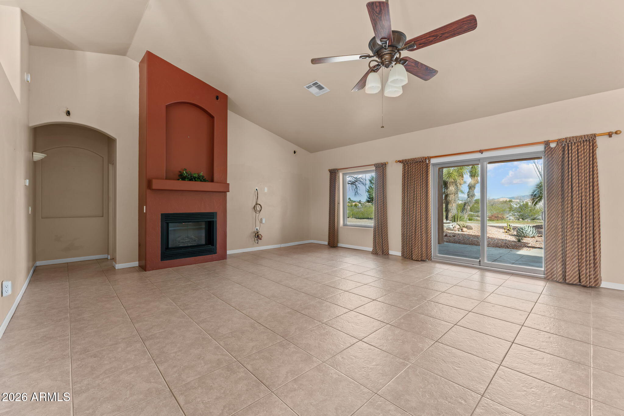 21340 Date Creek Road Wickenburg, AZ 85390 - Photo 6 of 35 a view of an empty room with a fireplace