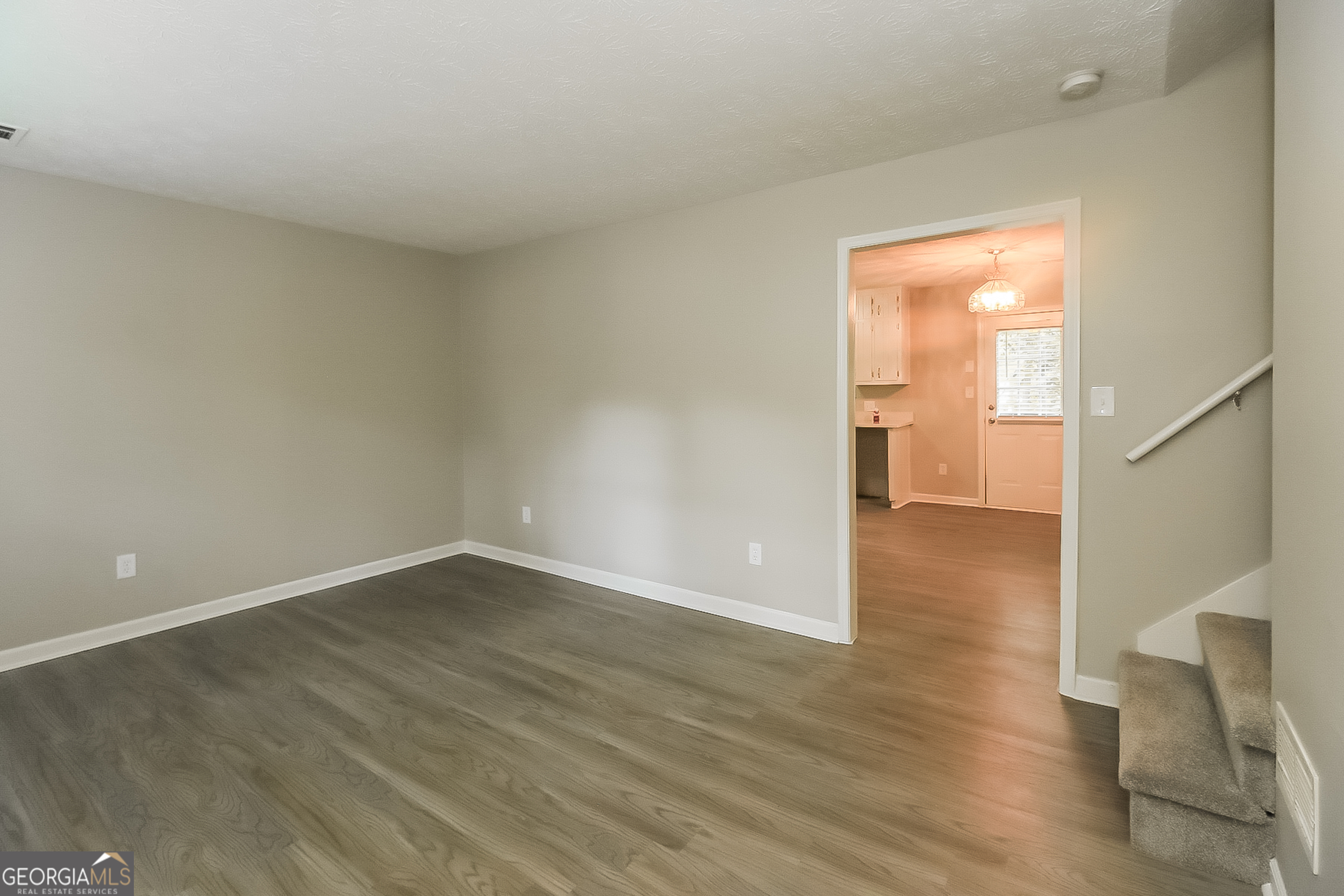 7548 Colonial Court Jonesboro, GA 30236 - Photo 6 of 17 a view of an empty room with wooden floor and a window