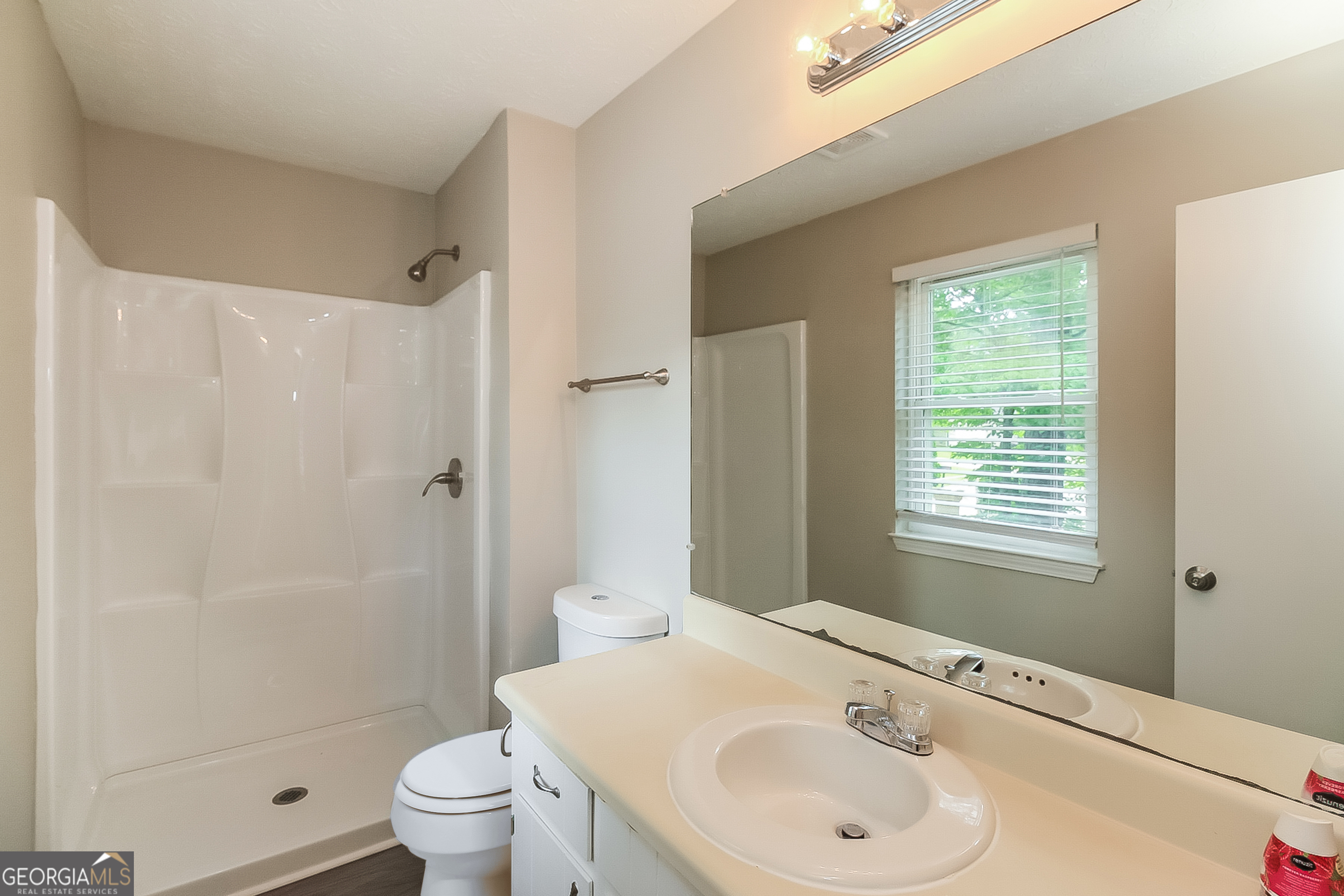 7548 Colonial Court Jonesboro, GA 30236 - Photo 10 of 17 a bathroom with a sink toilet and shower