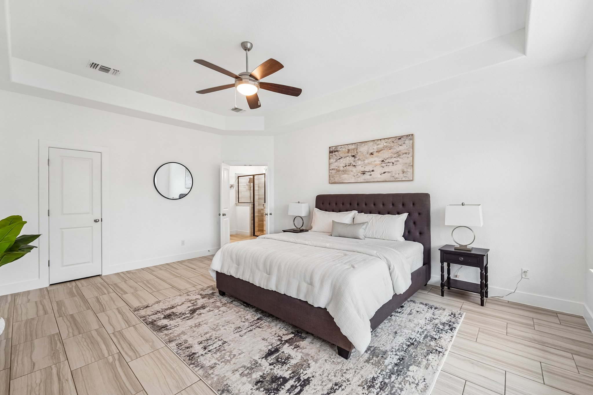 201 Potts Street Georgetown, TX 78628 - Photo 9 of 27 The primary suite is a true retreat, highlighted by an elegant tray ceiling and expansive layout.