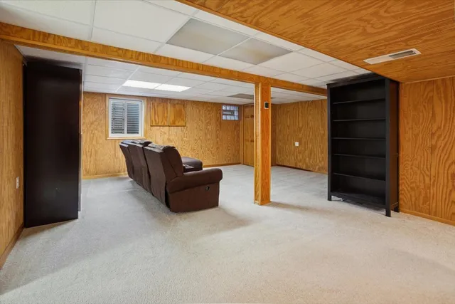 a living room with furniture and a dresser